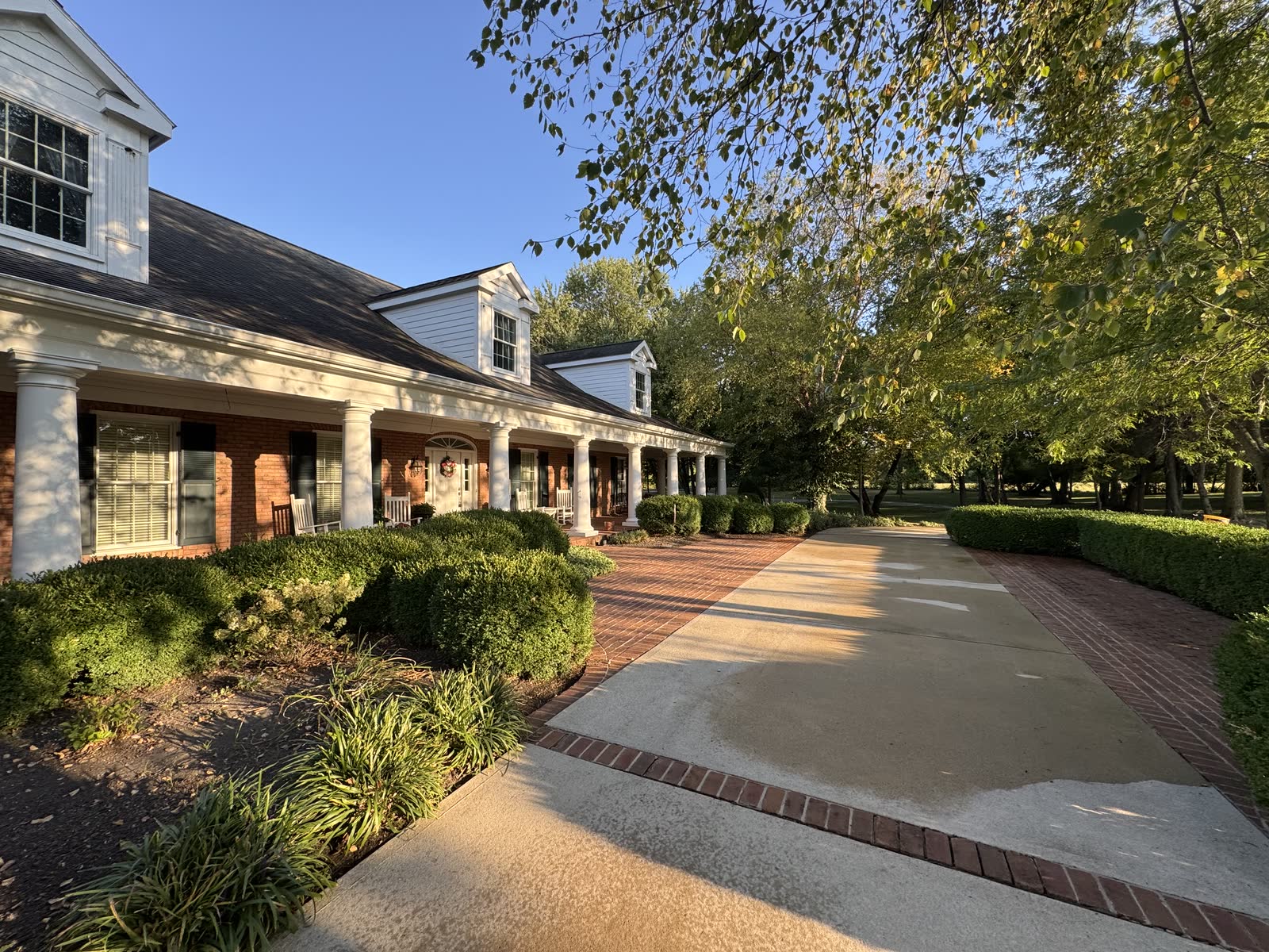 Home with a freshly pressure-washed concrete and brick driveway in Plain City, OH
