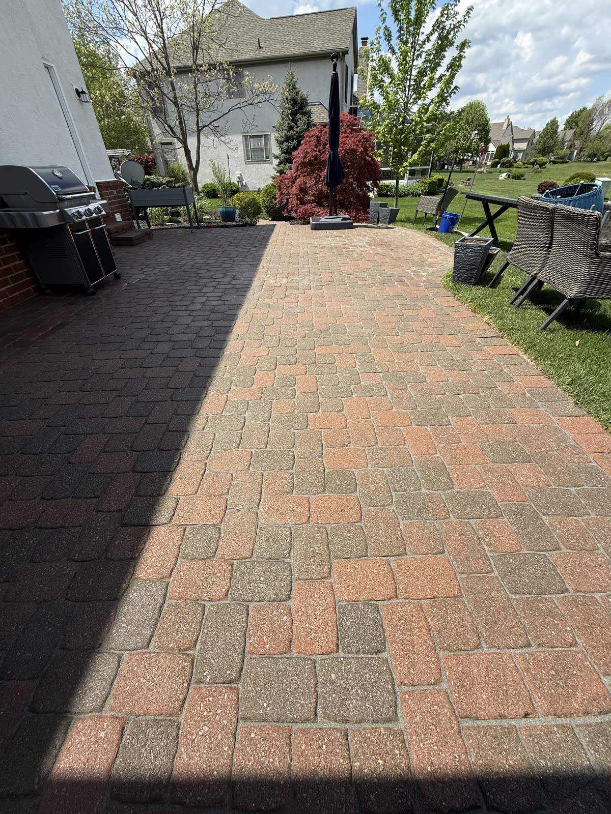 Paver surface pressure washed — dramatic clean vs. dirty split in Central Ohio