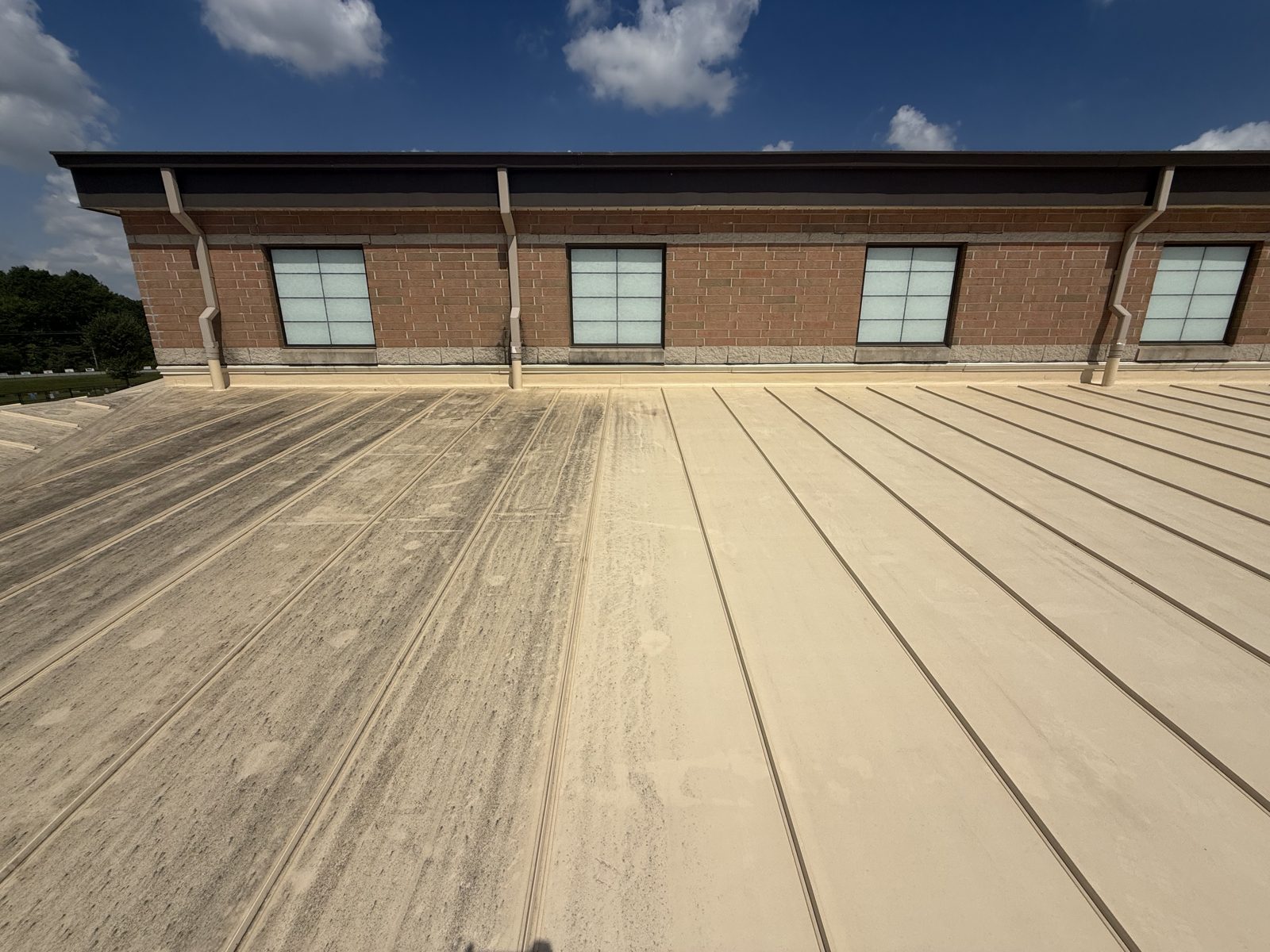 Commercial brick building with its metal roof washed clean by Mullet Power Wash in Central Ohio