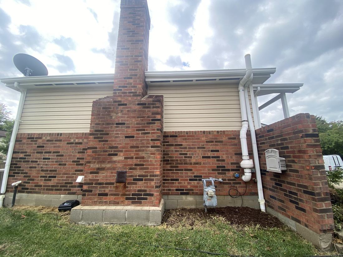 Brick chimney and foundation after washing by Mullet Power Wash
