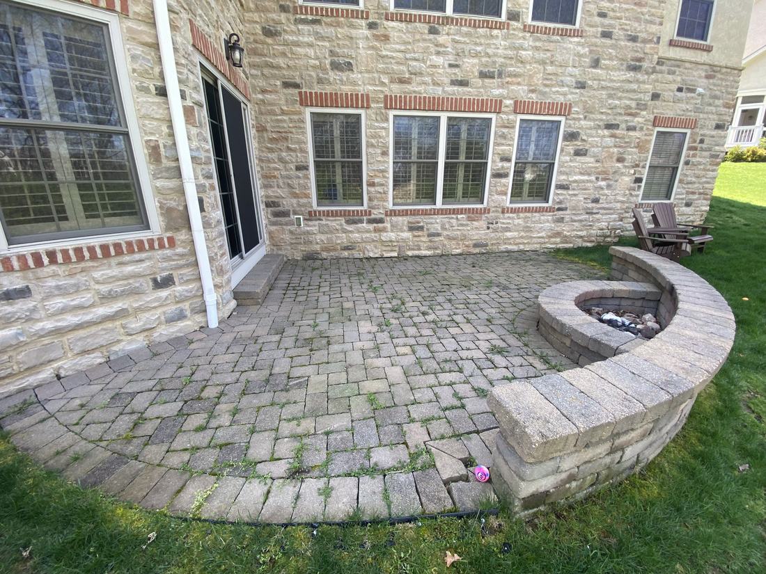 Brick courtyard and fire pit before washing