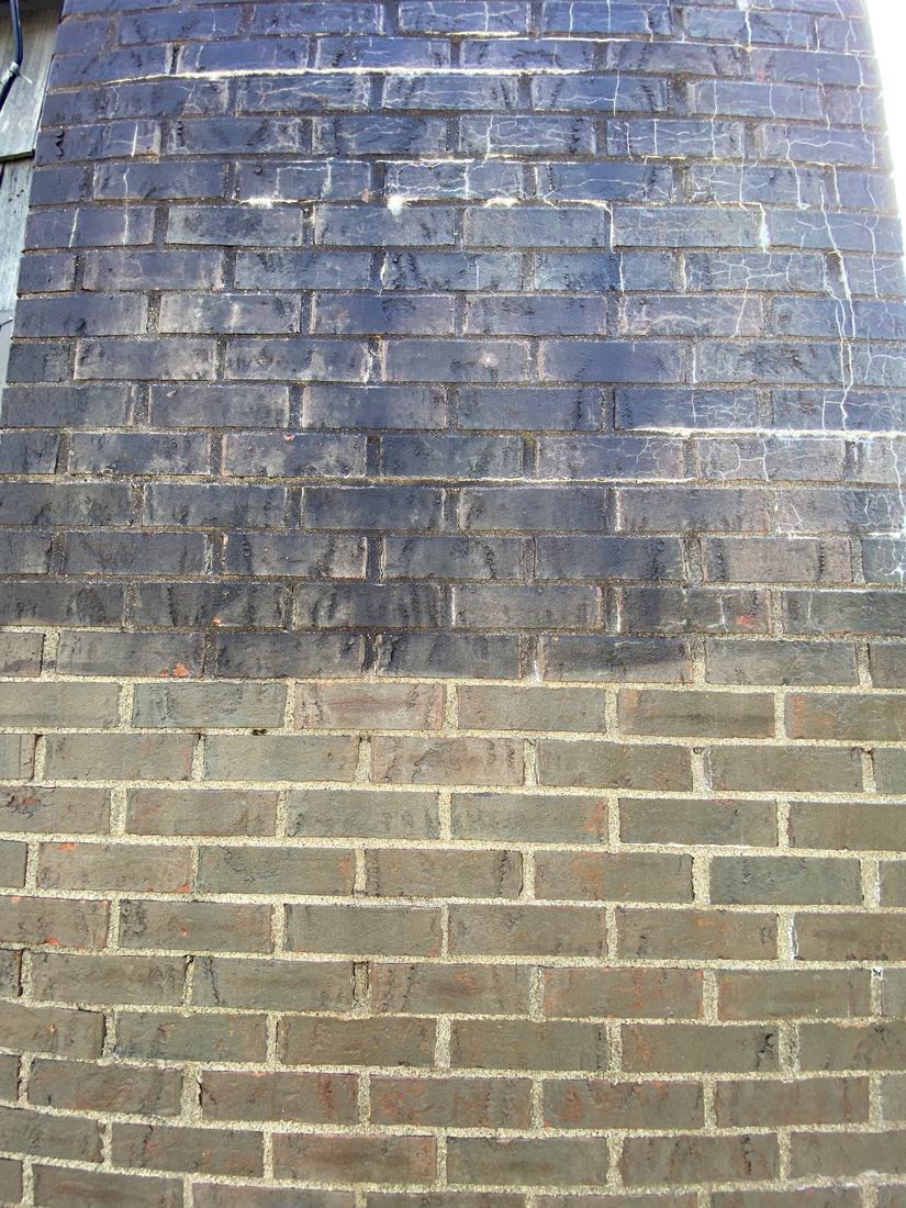 Brick wall, black staining lifted &mdash; before and after, shown together