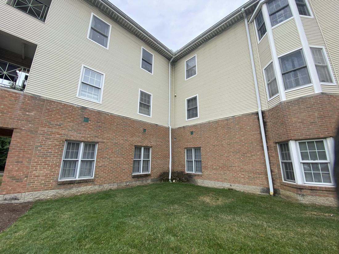Three-story condominium building after washing by Mullet Power Wash