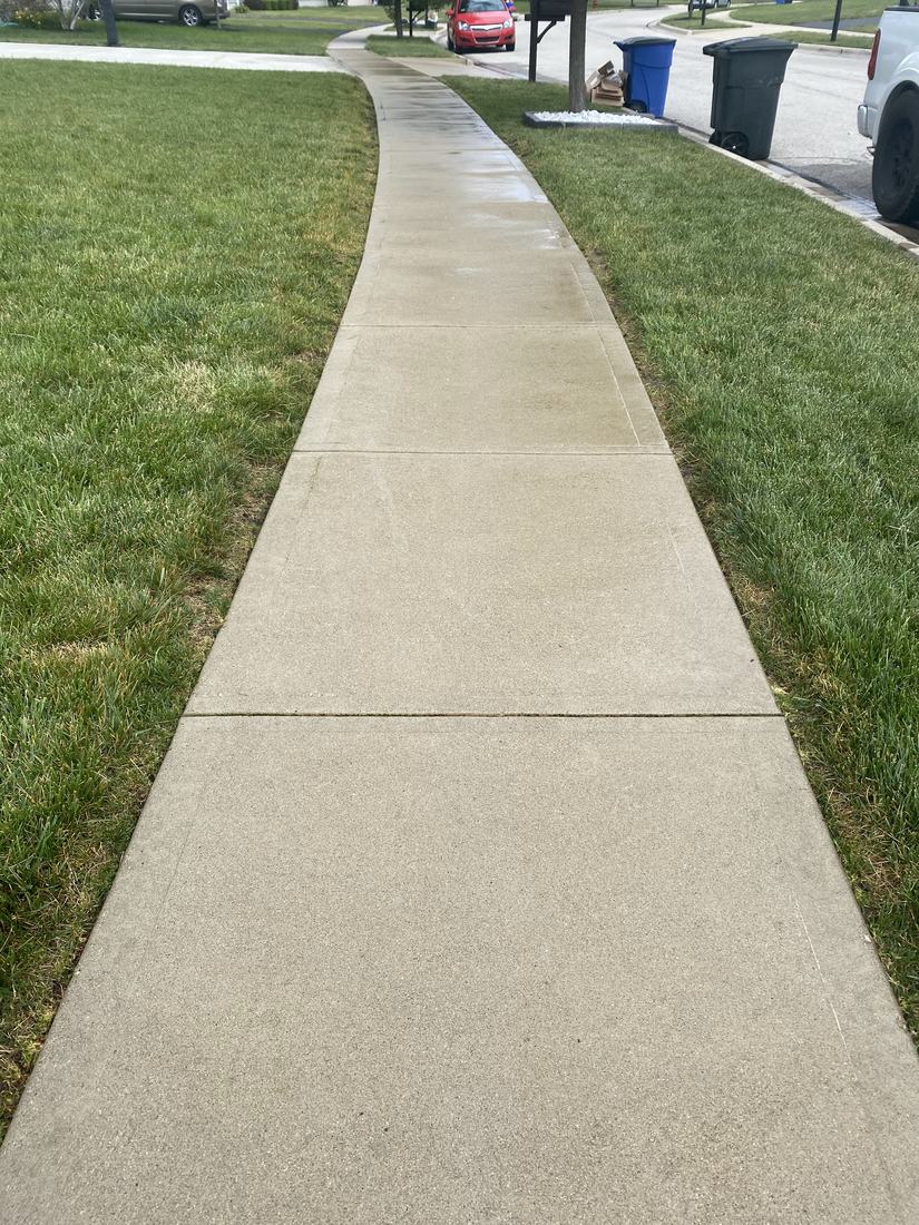 Curving sidewalk after washing by Mullet Power Wash