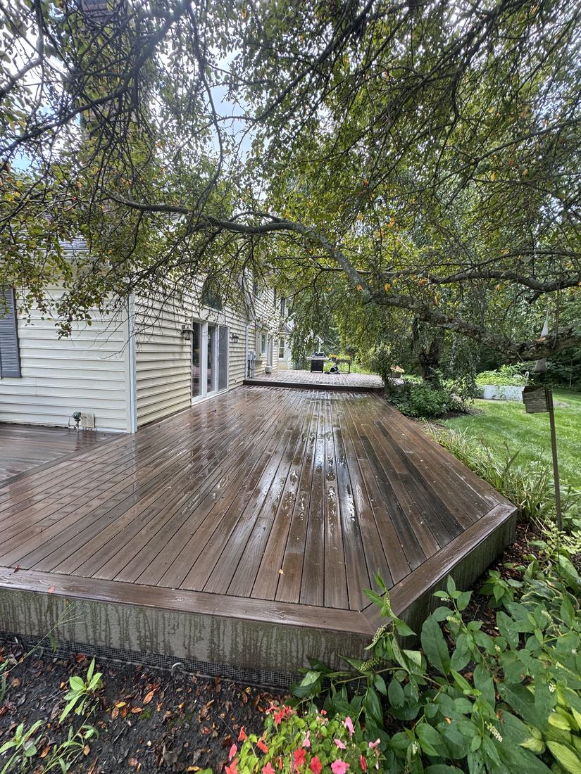 Wood deck being washed beside a Central Ohio home, the boards still wet