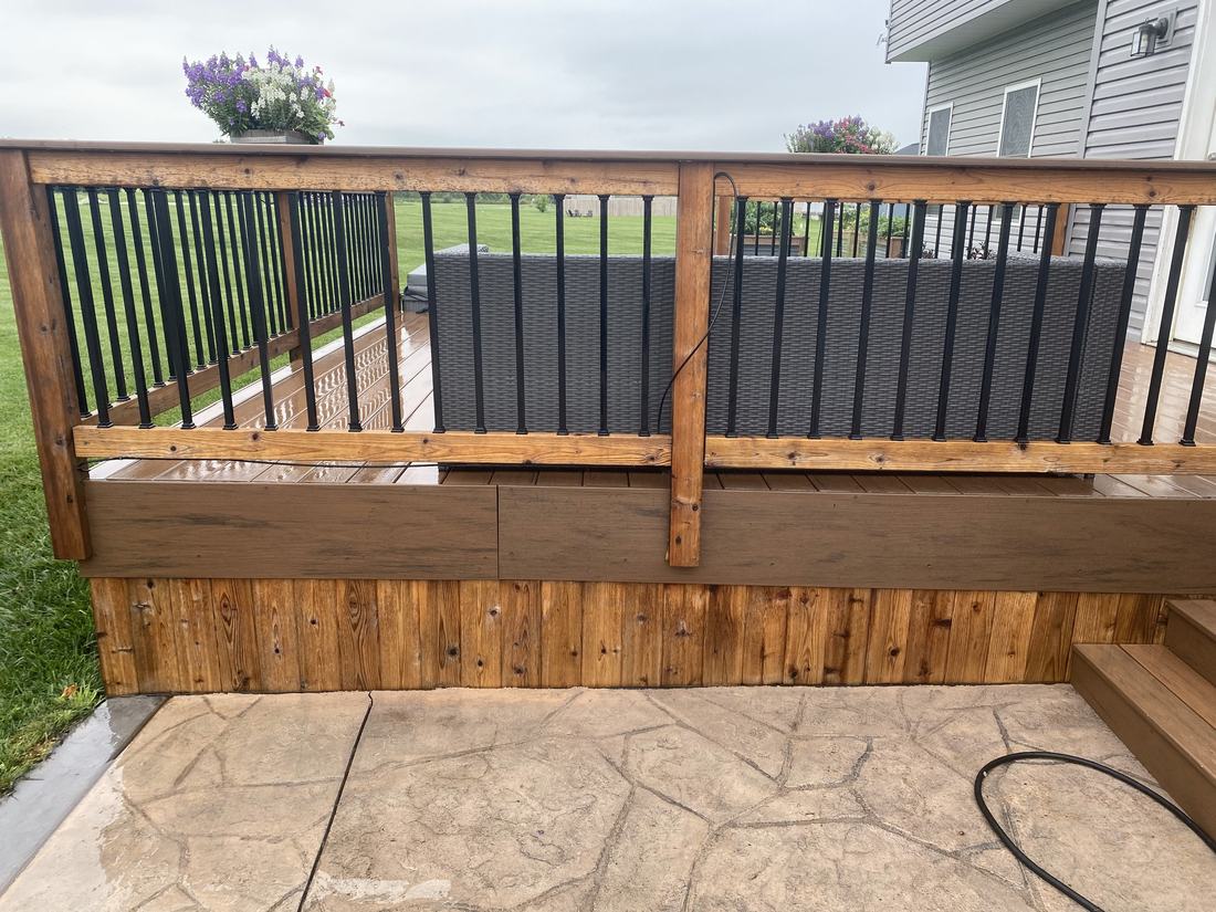 Washed wood deck skirting and black railings on a Central Ohio home