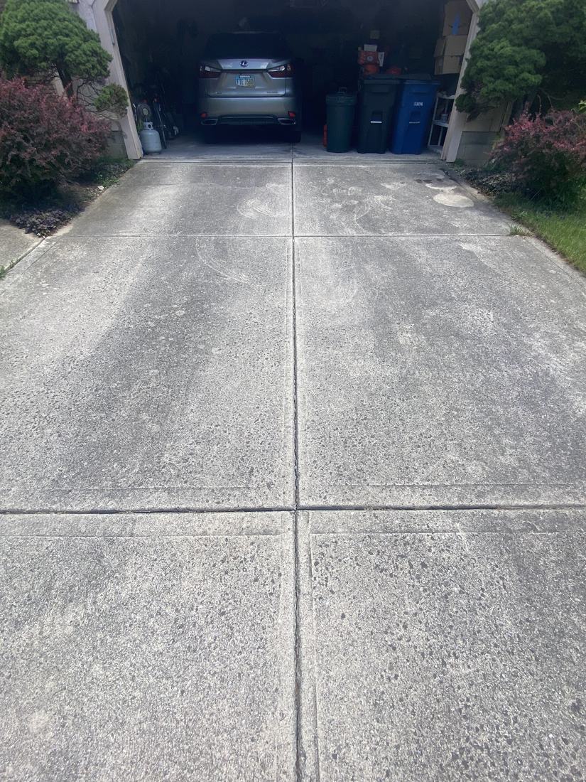 Clean concrete garage apron and driveway joints after a driveway wash