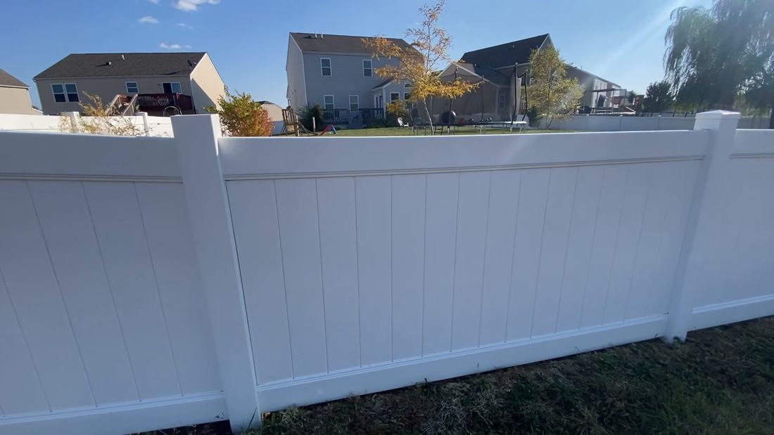 A vinyl privacy fence run after fence washing by Mullet Power Wash