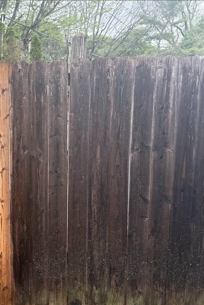 A wood privacy fence before fence washing