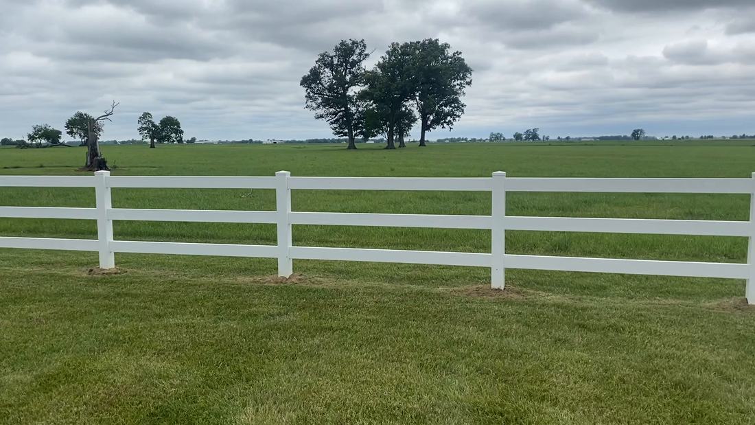 White three-rail farm fence washed clean in rural Central Ohio