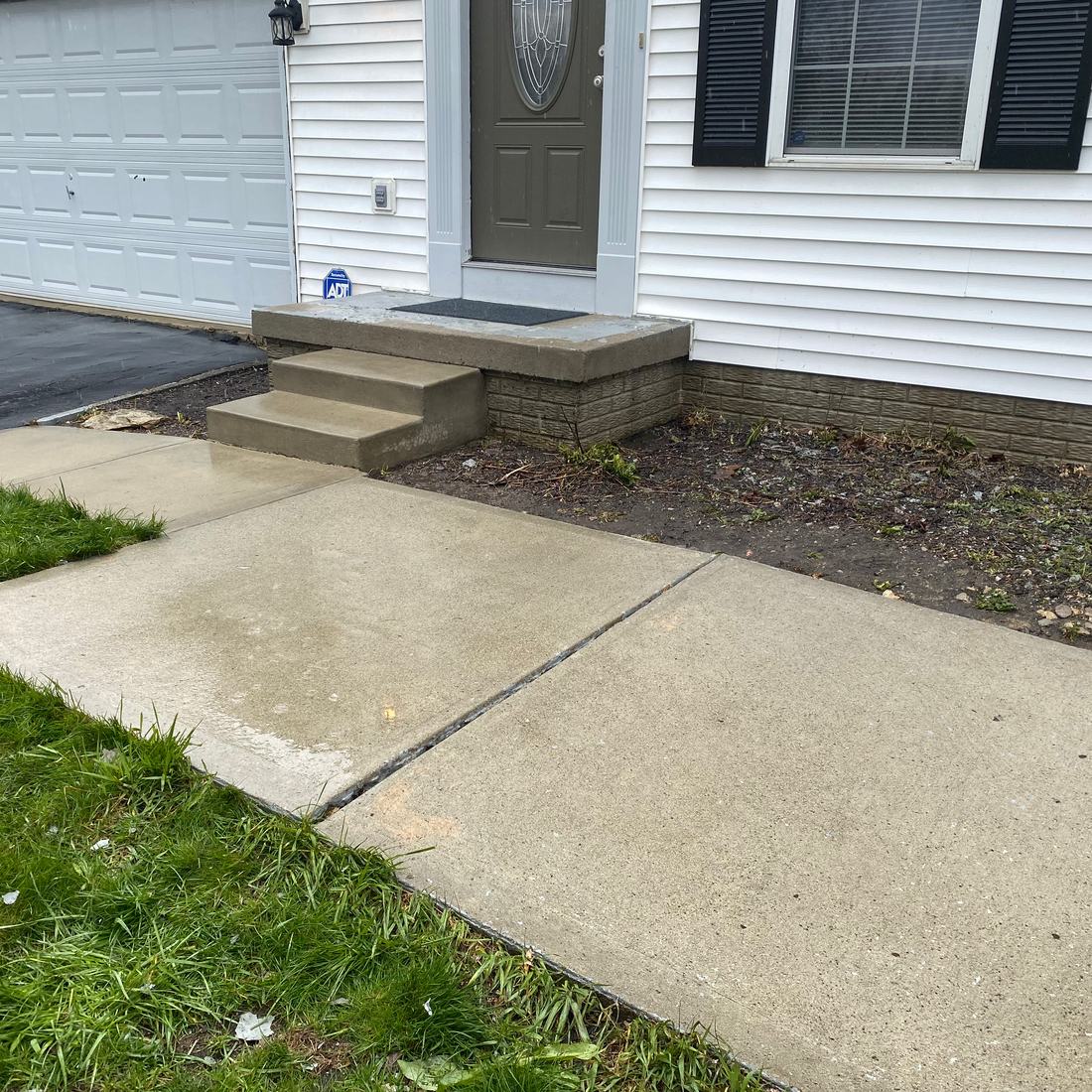 Front walk and stoop, oil stain out after washing by Mullet Power Wash