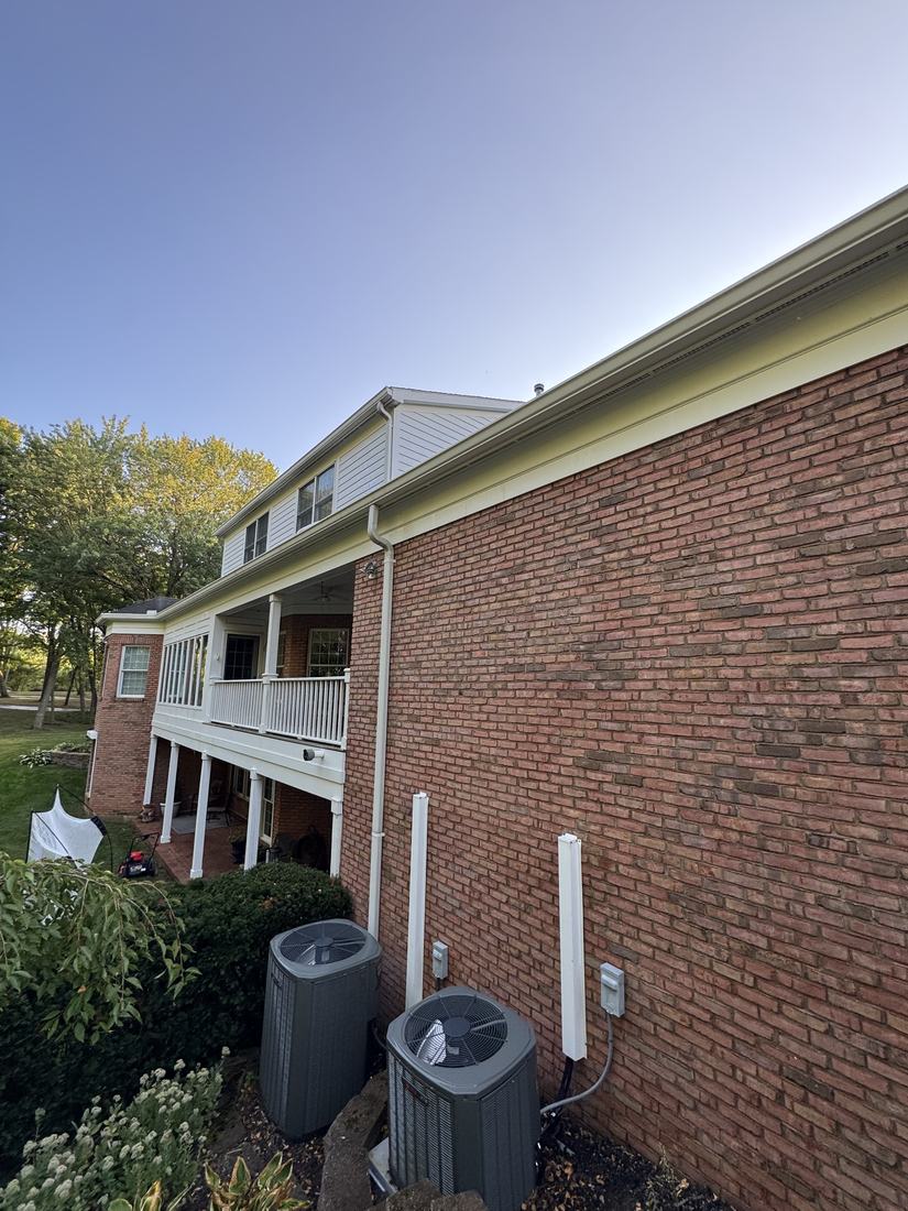 Gutters and downspouts along the brick side of a two-story Central Ohio home