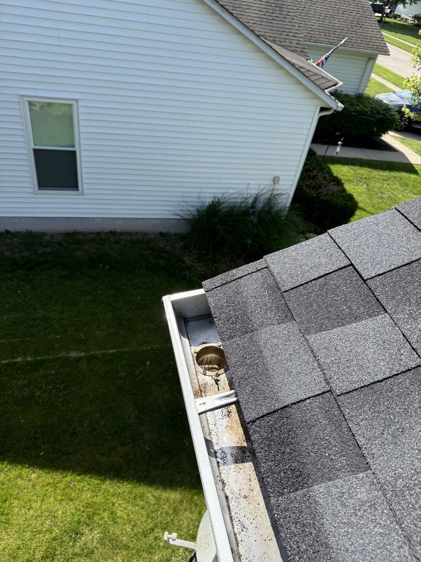 Clean gutter corner and downspout outlet on a Central Ohio home