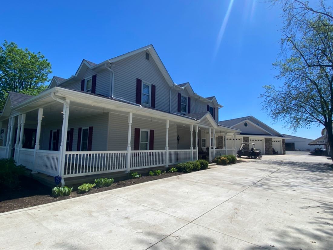 Long covered porch and white siding cleaned on a Central Ohio home