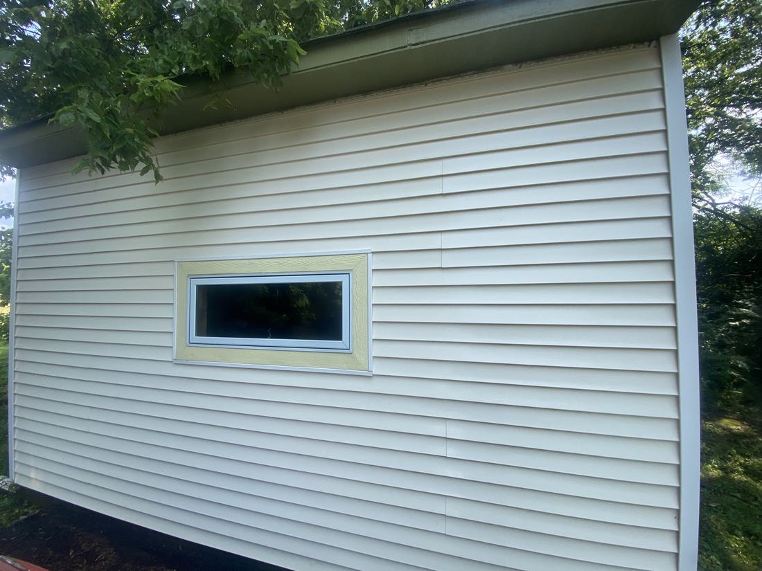 Close-up of clean vinyl siding and window trim after a soft wash