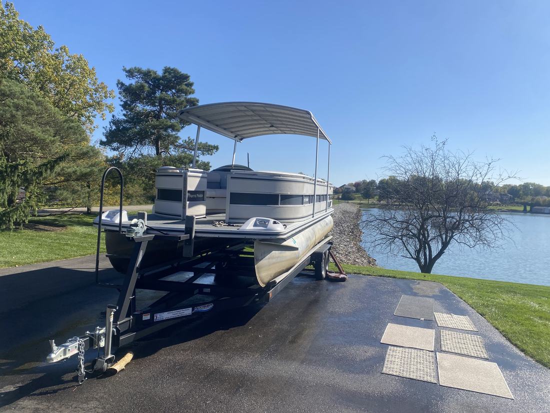 Pontoon boat on its trailer beside a Central Ohio lake after washing