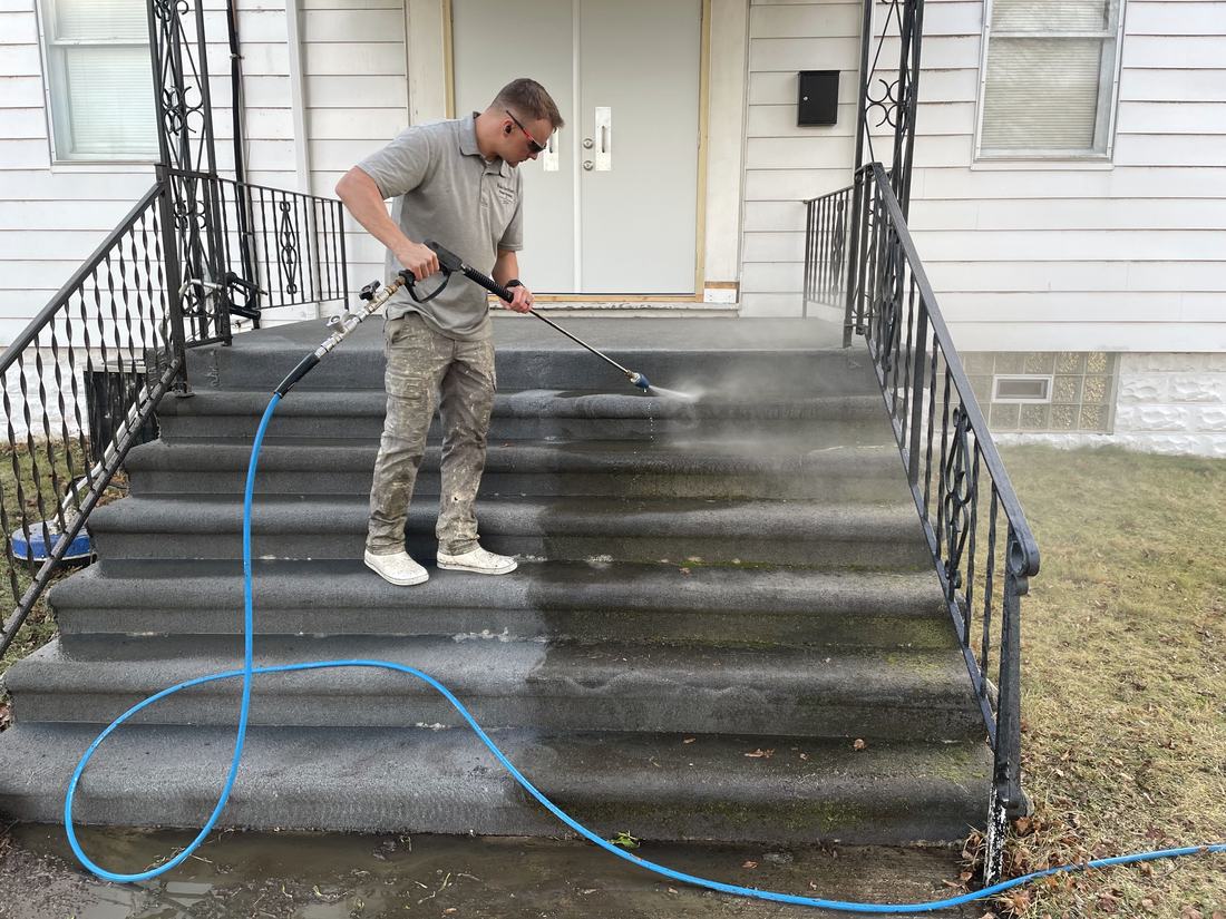 Mullet Power Wash cleaning concrete front steps and a handrail at a Central Ohio home