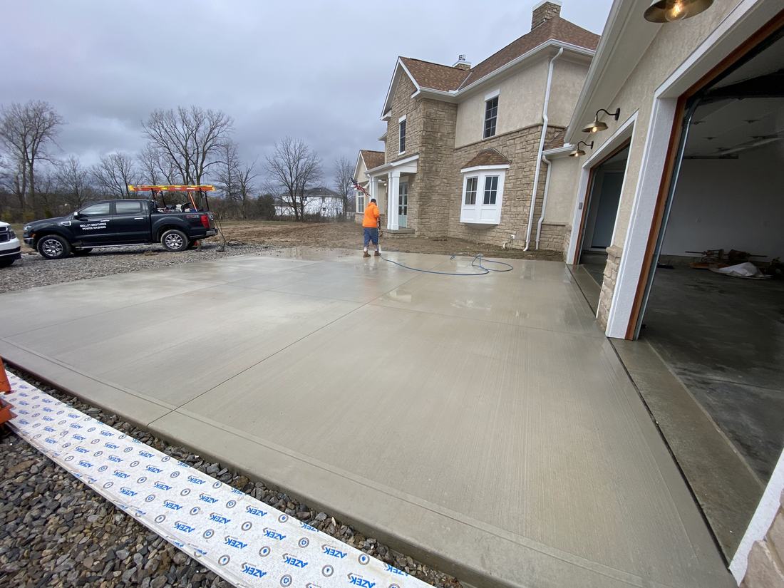 Front of a Central Ohio home with freshly washed concrete driveway and apron