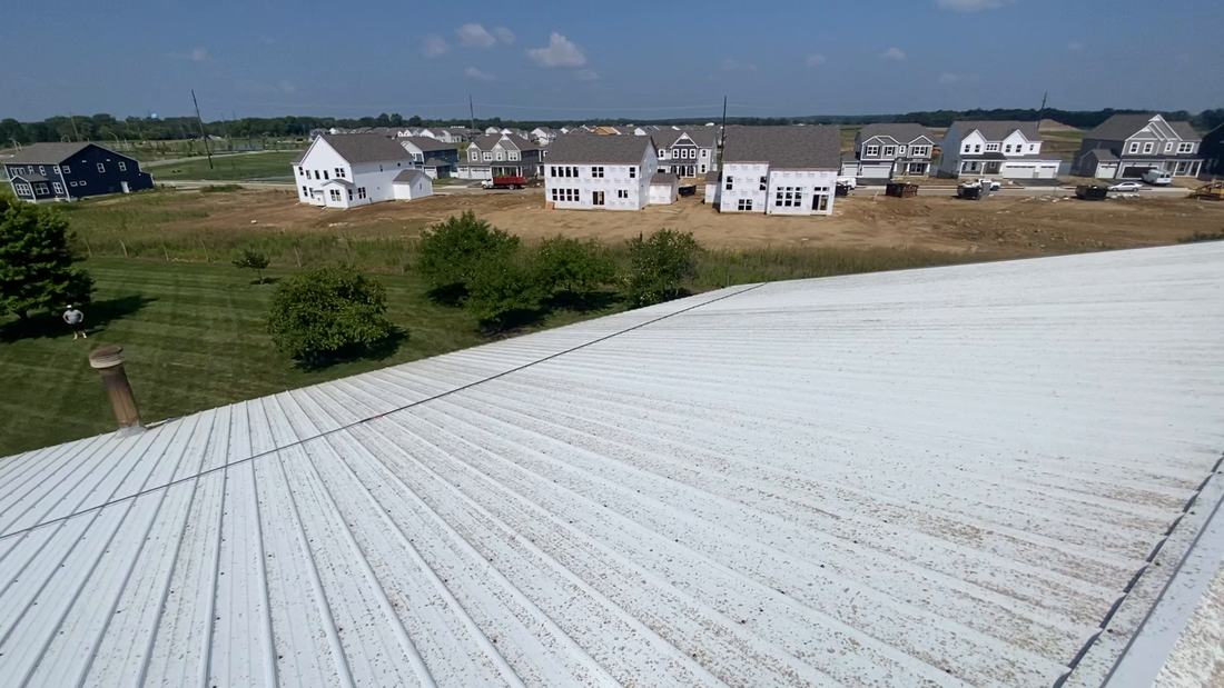 Washed white metal roof overlooking a new Central Ohio neighborhood
