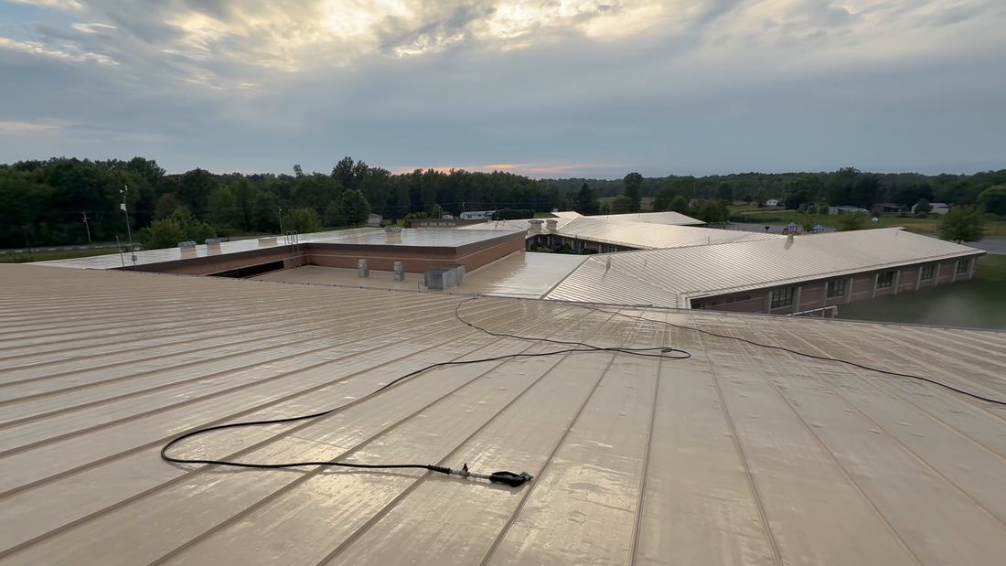 Clean standing-seam metal roof on a Central Ohio school, seen from the top