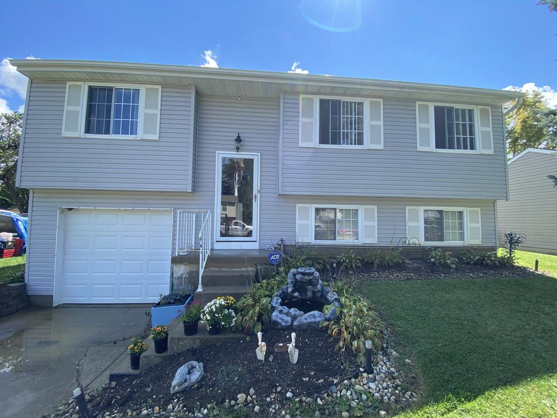 Split-level home, front after washing by Mullet Power Wash