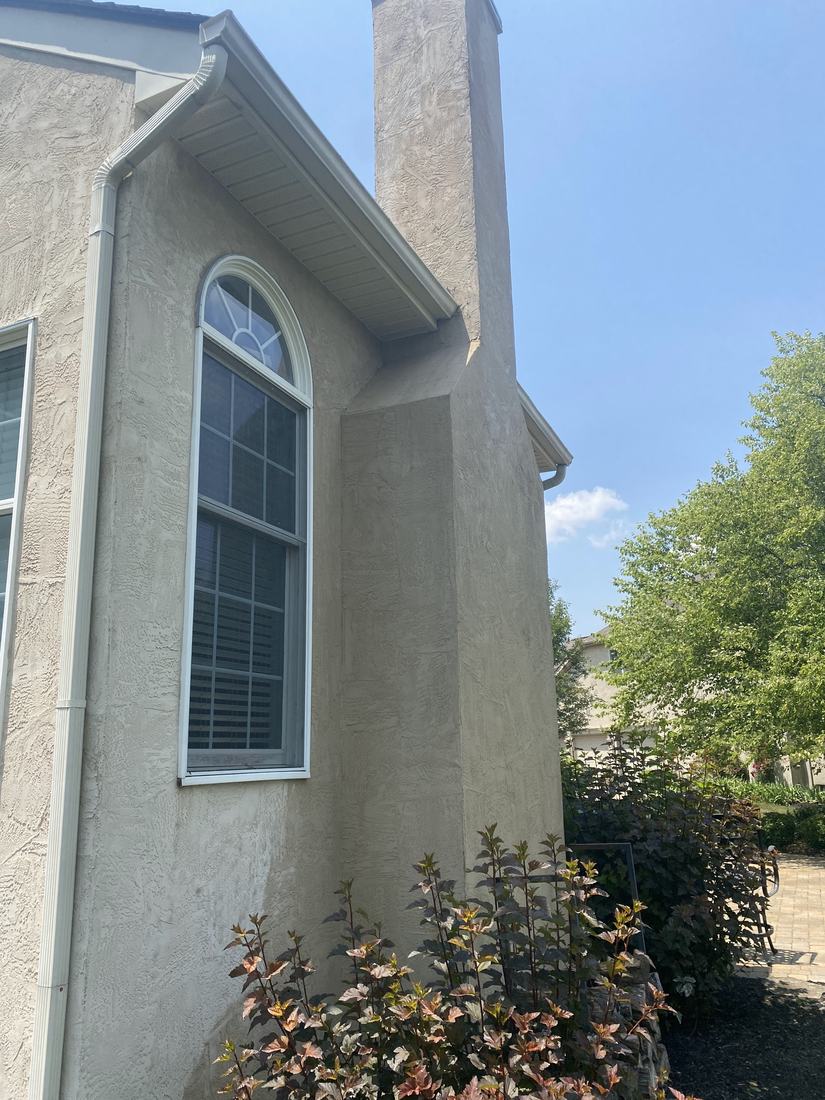 Stucco chimney chase after washing by Mullet Power Wash