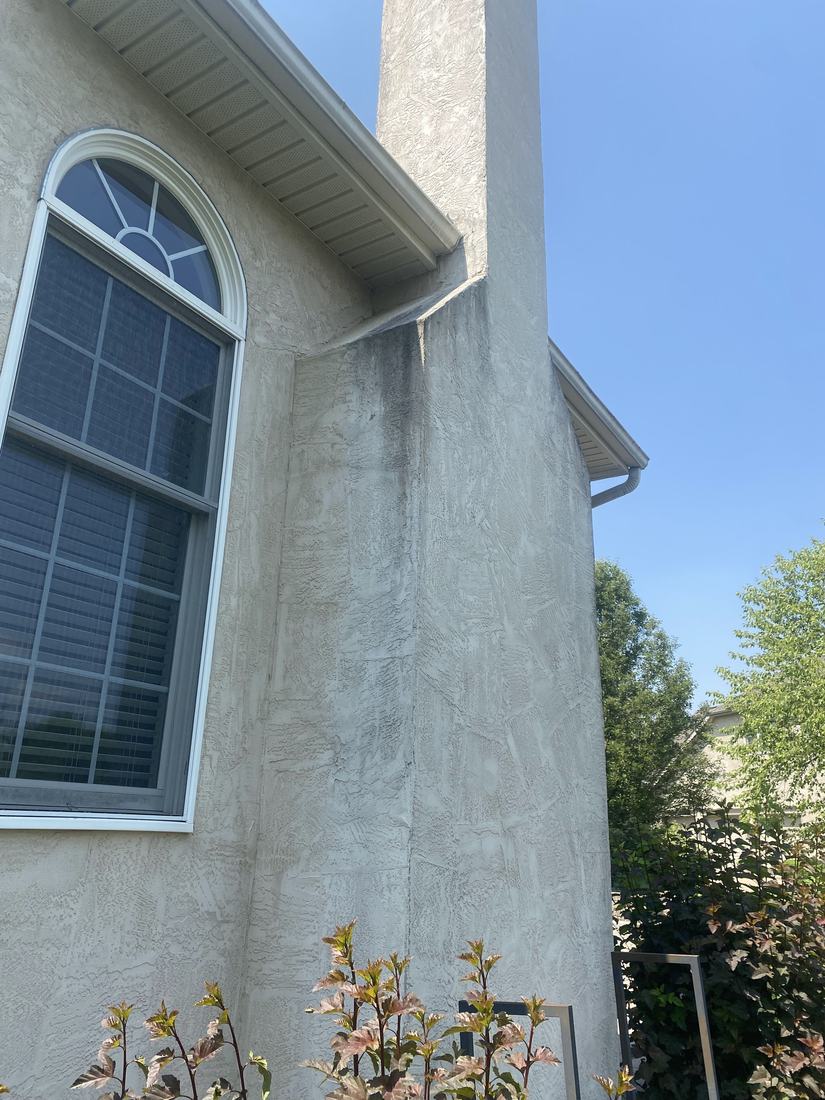 Stucco chimney chase before washing
