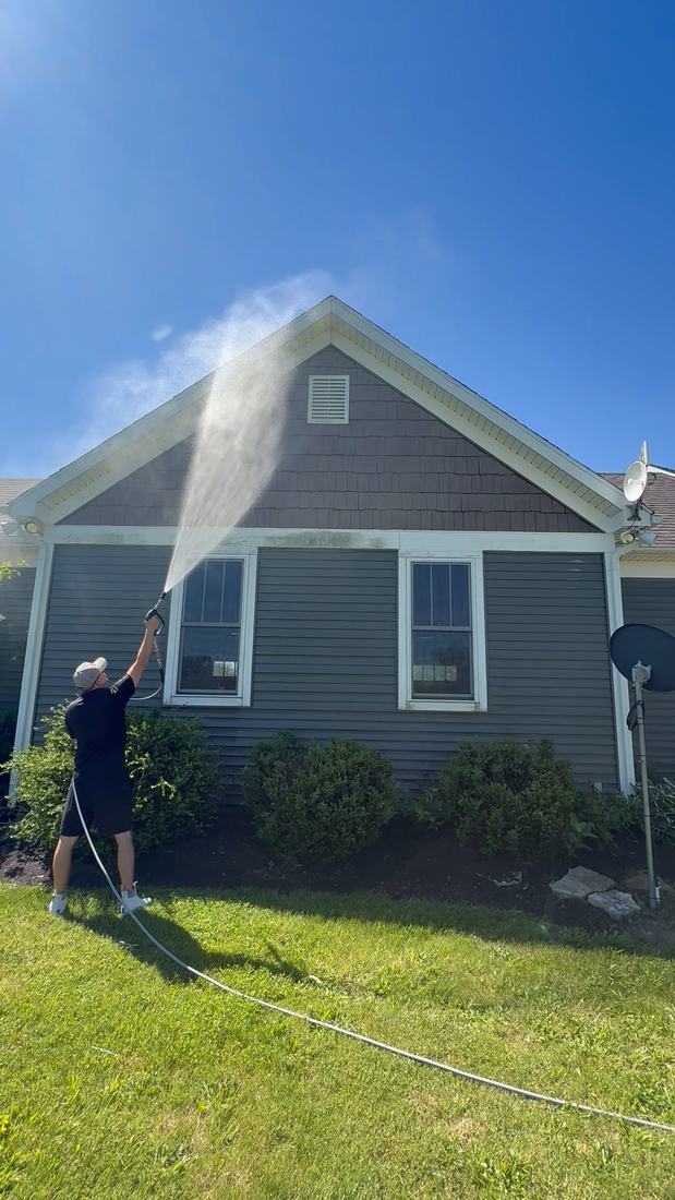 Mullet Power Wash soft washing the gable of a gray-sided home in Central Ohio