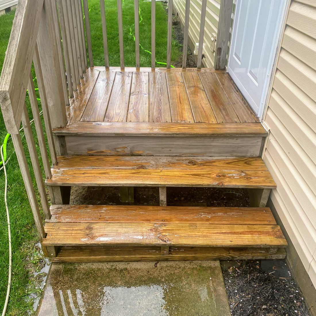 Wooden entry steps after washing by Mullet Power Wash