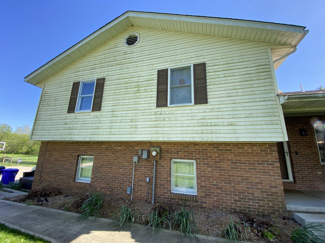 Yellow siding over brick before washing